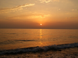 Beautiful dawn over the sea. Sunny path on the water. Light wave and swell on the surface of the water
