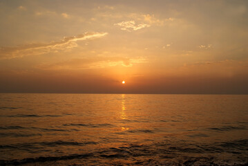 Fototapeta premium Beautiful dawn over the sea. Sunny path on the water. Light wave and swell on the surface of the water