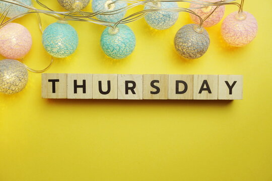 Thursday alphabet letter with LED Cotton ball Decoration on yellow background