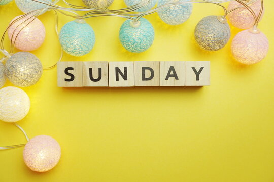Sunday alphabet letter with LED Cotton ball Decoration on yellow background