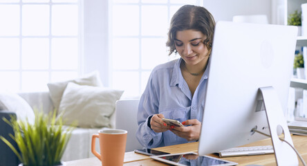 Young woman working with graphic tablet in office