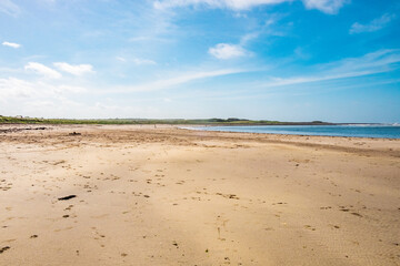 A beach at the north coast of Scotland, on a sunny day.