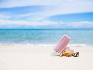 Sunsreen protection UV A,UV B. on sand beach and blur image of sea. for contains articles about the sea or travel summer in holidays.