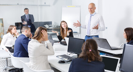 Ordinary manager expressing dissatisfaction with teamwork of colleagues at meeting