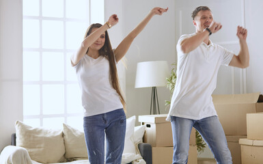 Lovely couple dancing in new empty flat