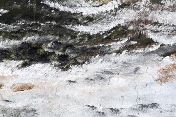 Abstract creative background of chaotic strokes of old cracked paint on concrete wall. Old surface with traces of paint, weathered, scratches and cracks for design