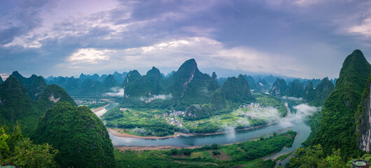 The classic Asian natural scenery, located near the Li River in Guilin, China. Green nature background picture, panoramic picture.