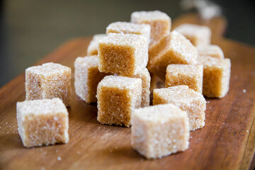brown sugar cubes on a wooden board