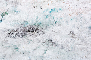 Abstract creative background of chaotic strokes of old cracked paint on concrete wall. Old surface with traces of paint, weathered, scratches and cracks for design