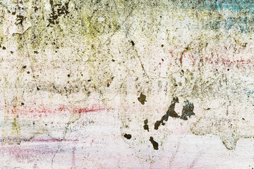 Abstract creative background of chaotic strokes of old cracked paint on concrete wall. Old surface with traces of paint, weathered, scratches and cracks for design