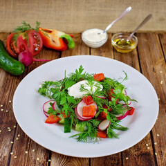 Salad with cucumbers and radishes with greens