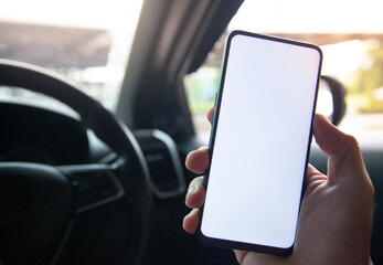 Hand holding use smartphone new model, For searching for directions, in the latest car models.Concept of using a car phone.