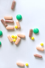Collection of colorful various pills on white table background