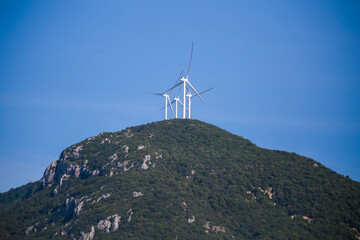 Fototapeta na wymiar wind genarators turbines on the pick of the mountain in Despotiko village at Ioannina perfecture greece