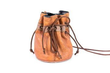 Old leather drawstring bag with brown string tied isolated on white background. Small old brown...
