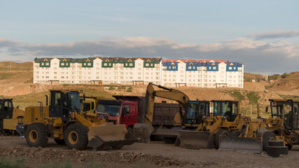 Construction Site, construction machinery, bulldozer, excavation, buildings. Panorama.