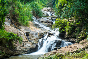 Closeup of  Mae Sa waterfall in Chiang Mai, Thailand. Fresh green maesa waterfall with rock and trees background