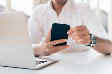 Middle section adult man usign smartphone - Close up business man holding mobile phone - working, 5g technology, internet concept