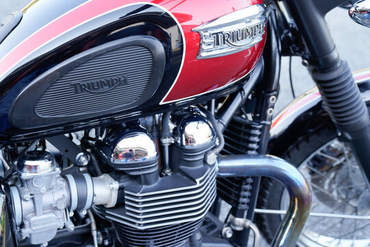 triumph vintage logo sign and text on motorcycle detail on red fuel tank on motorbike classic