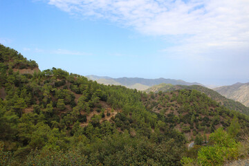 Fototapeta na wymiar Troodos mountains from the observation platform of the Kykkos monastery against the blue sky. Cyprus.