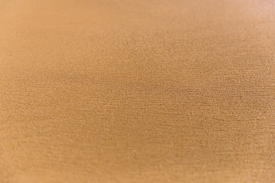 Yellow sand background. Selective focus.