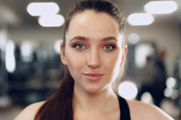 Fototapeta na wymiar Portrait of a young sporty caucasian woman training in a fitness club