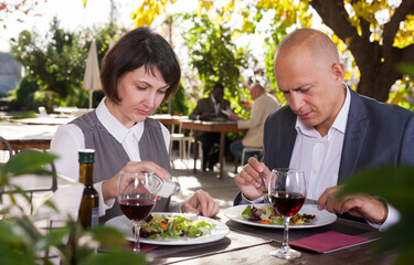 Couple in love eating dinner at restaurant summer terrace. High quality photo