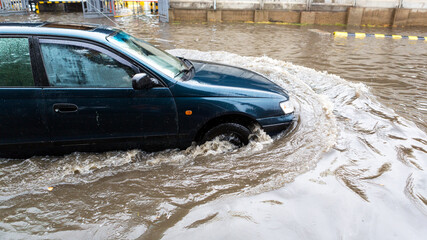 Odessa, Ukraine - September 20, 2016: Driving cars on a flooded road during flooding caused by...