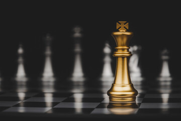 Leadership. gold king with silver chess pieces on chess board game competition on dark background,...