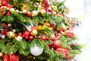 close up of christmas trees decoration with toys and garlands. City festive decor during winter holidays