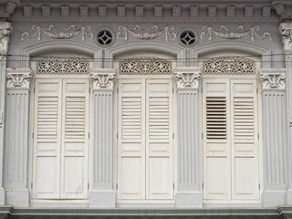 Traditional white shutters of a shop house in Little India - Singapore