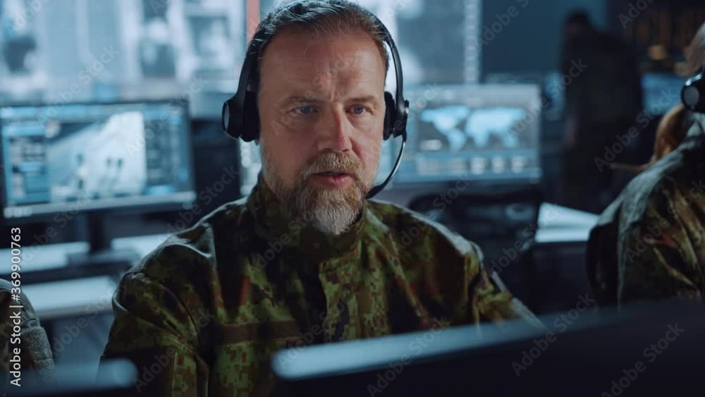 Aufkleber bearded military surveillance officer in headset working in a central office hub for cyber operation
