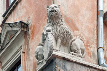 Old house facade decoration depicting lion with shield in Lviv, Ukraine