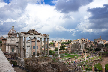 Fototapeta na wymiar Roman forum under the sun against a stormy sky. Italy.