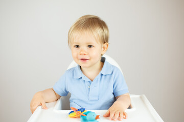 Portrait of a beautiful blond baby sitting smiling