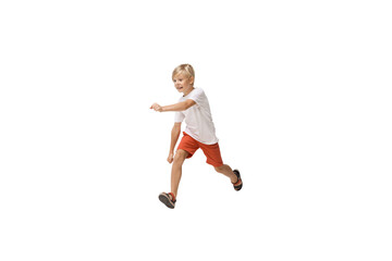 Fototapeta na wymiar Energy. Happy kids, little and emotional caucasian boy jumping and running isolated on white background. Look happy, cheerful, sincere. Copyspace for ad. Childhood, education, happiness concept.