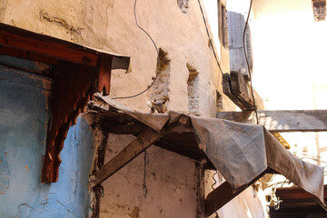 Cat sleeping on a tent above a shop in the street of Moroccan medina in Marrakesh