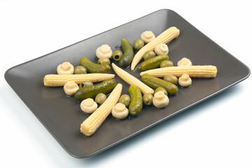 Olives, pickled cucumber, mushrooms and corn in a salad on a plate. food and vegetables. diet and weight loss