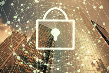 Lock icon hologram on city view with skyscrapers background multi exposure. Data security concept.