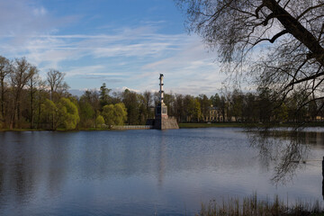 The Chesma column, located in the Big lake of the Catherine Park, is surrounded by trees. Against...