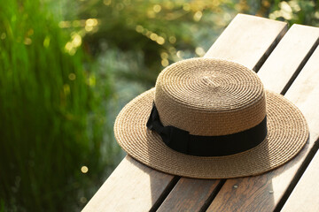 brown traveling woman hat on wood terrace with outdoor lake view sunlight nature background