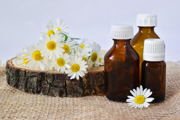Glass bottles with chamomile flowers
