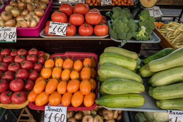 A colorful assortment of fresh fruits and vegetables neatly and attractively arranged on stands for sale at Riga Central Market, Latvia.