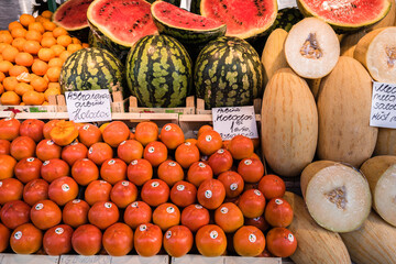 A colorful assortment of fresh fruits and vegetables neatly and attractively arranged on stands for sale at Riga Central Market, Latvia.