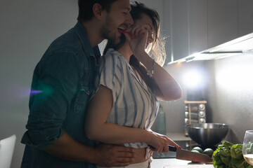 Young couple cooking tasty dinner together in a kitchen