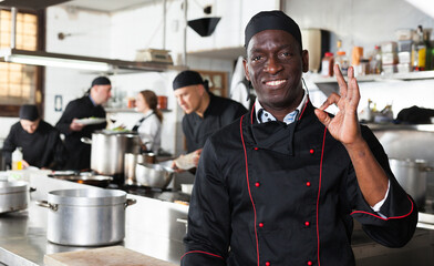 African american professional chef male in kitchen of restaurat. High quality photo