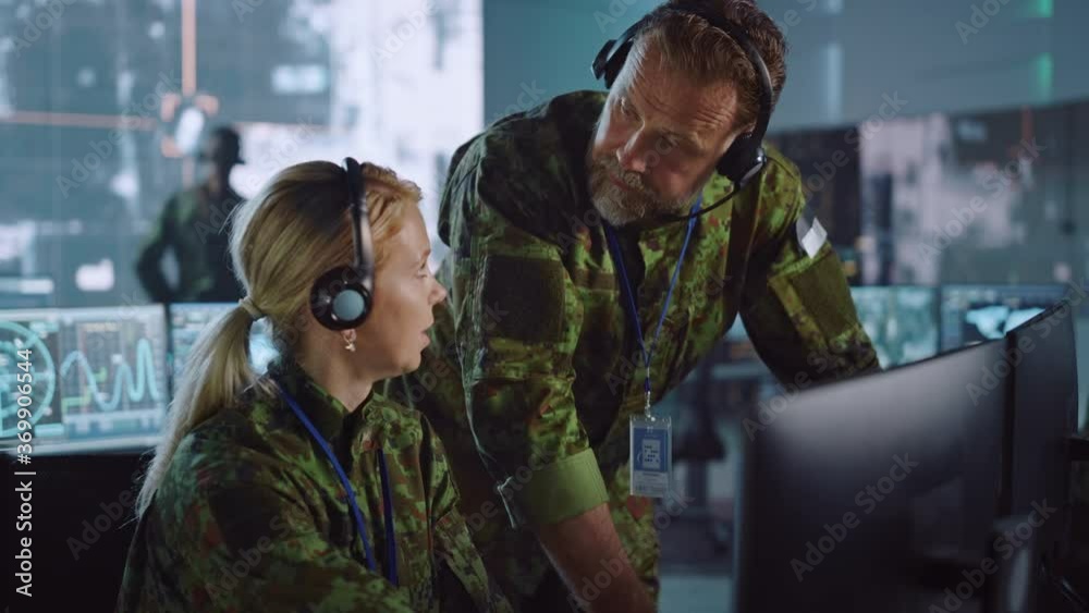 Aufkleber military surveillance officers talking next to a computer screen in central office for cyber operati