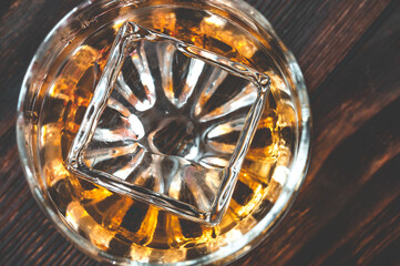 Glass of whiskey with ice cube