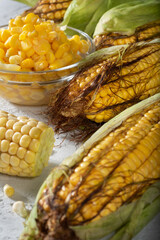 Sweet fresh corn on the cob on a light concrete background