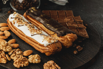 Eclair cake on dark wooden board on black table